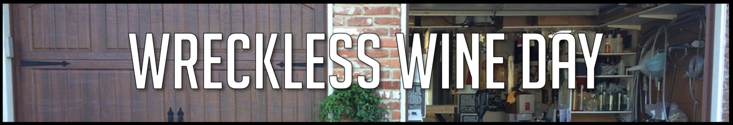 Wreckless Wine Day banner across the winery garage and barrel room.