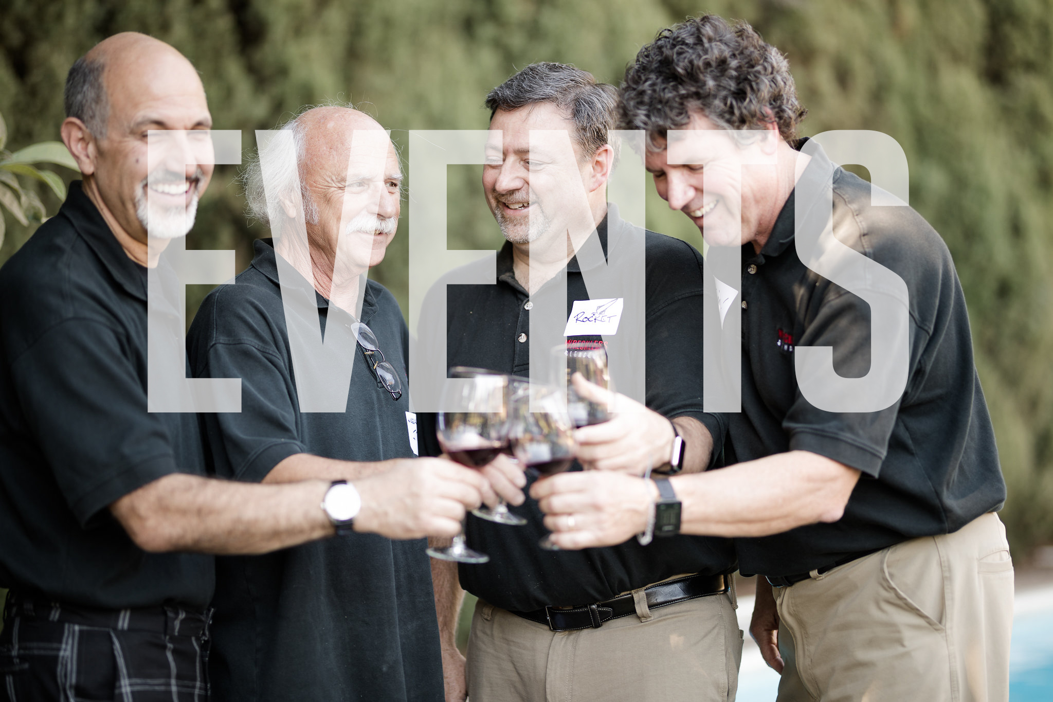 Wreckless Blenders team members sharing wine at an outdoor event.